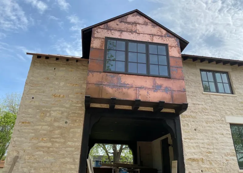 Copper metal panel facade on a stone building for Skylight Installation in Ellettsville
