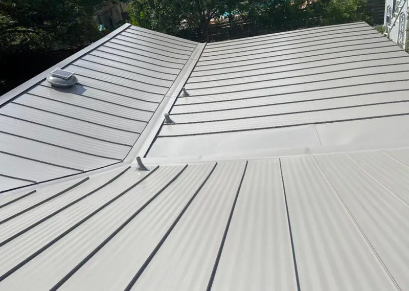 Solar attic fan installed on a metal roof for Roof Ventilation in Ellettsville